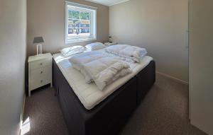 a large bed in a bedroom with a window at Gorgeous Apartment In Drangedal in Drangedal