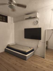 a room with a bed and a flat screen tv at private house near Jerusalem in Beit Shemesh