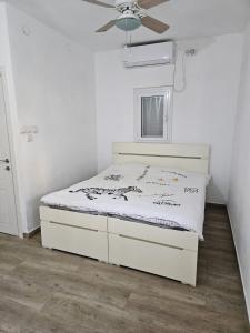 a bedroom with a bed in a white room at private house near Jerusalem in Beit Shemesh
