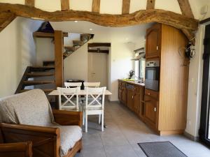 a kitchen with a table and chairs in a room at La Chaumière in Flancourt-Catelon +12 photos