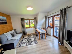 a living room with a couch and a table at Willa Murań in Murzasichle
