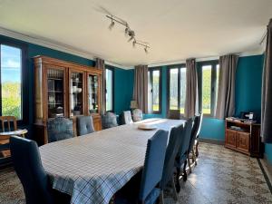 a dining room with a large table and chairs at La longère in Flancourt-Catelon