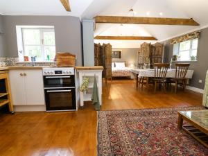 a kitchen and living room with a table and a dining room at The Old Dairy in Warminster +14 photos