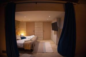 a bedroom with a large bed in a room at L'Escapade in Baugé