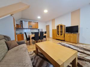 a living room with a couch and a table at Villa Hukic in Tuzla
