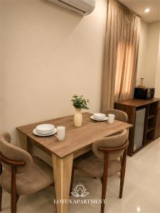 a dining room table with two chairs and a table at Lotus Two Hotel l New Cairo in Cairo
