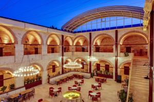 a large building with tables and chairs in it at Silk Road Museum Hotel in Tokat