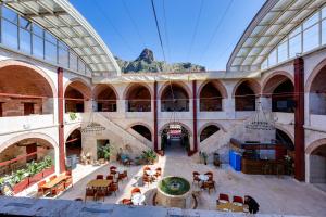 an indoor building with a fountain and tables and chairs at Silk Road Museum Hotel in Tokat