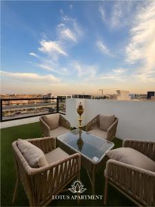 a patio with couches and a table on a roof at Lotus Two Hotel l New Cairo in Cairo