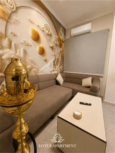 a living room with a couch and a table at Lotus Two Hotel l New Cairo in Cairo