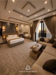a hotel room with two beds and a couch at Lotus Two Hotel l New Cairo in Cairo