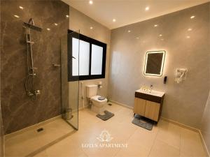 a bathroom with a shower and a toilet and a sink at Lotus Two Hotel l New Cairo in Cairo +26 photos