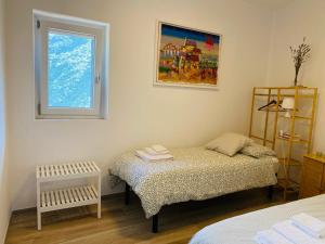 a bedroom with two beds and a window at La casina di Viola in Posticciola