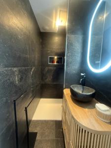 a bathroom with a sink and a mirror at L Œil de L Horizon in Lanildut