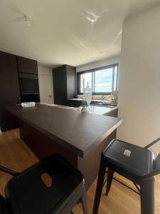 a kitchen with a large counter and a chair at L Œil de L Horizon in Lanildut +3 photos