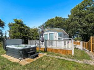 a backyard with a hot tub and a grill at Margaret's in Brigham