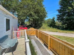 a wooden deck with a bench and a fence at Margaret's in Brigham +12 photos