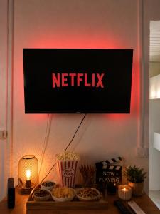 a sign that reads netflix on a wall with food at URBAN LOFT- Espace détente in Fort-de-France