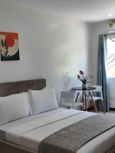 a bedroom with a bed and a table with chairs at Ricres Hometel R3 in Babak +1 photo