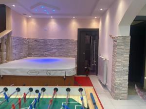 a room with a bed and a pool table at Villa Ennio in Ciampino