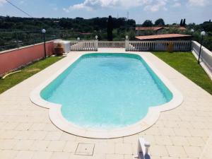 a large swimming pool on a patio at Villa Ennio in Ciampino