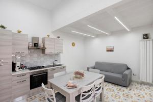a kitchen with a table and a couch in a room at La Casa Di Zio Michelino in Pimonte