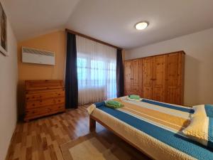 a bedroom with a large bed and a window at Villa Hukic in Tuzla