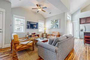 a living room with a couch and a ceiling fan at Hola Beaches in Corolla