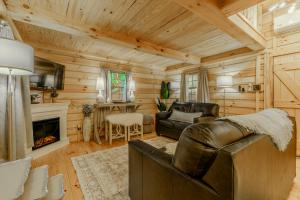 a living room with a couch and a fireplace at Peaceful Luxury in the Smokey Mountains w Hot Tub and Pet Friendly Cabin B in Elizabethton