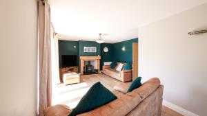 a living room with a couch and a tv at Firsbrook House - Wark Northumberland in Wark