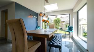 a dining room with a wooden table and chairs at Firsbrook House - Wark Northumberland in Wark