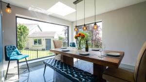 a dining room with a table and chairs and a window at Firsbrook House - Wark Northumberland in Wark +40 photos