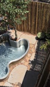 a swimming pool with a tree in a backyard at Healing Hands in Merom Golan