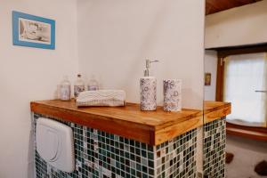 a bathroom with a counter with a sink and toiletries at Casa Acquarossa in Rubiana