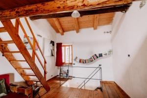 a room with wooden ceilings and a wooden staircase at Casa Acquarossa in Rubiana +19 photos