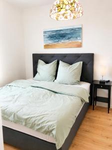 a bedroom with a large bed with a black headboard at Troisdorf - City - 64Qm - 1 bis 3 Schlafplätze in Troisdorf