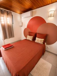 a bedroom with a large red bed in a room at URBAN LOFT- Espace détente in Fort-de-France