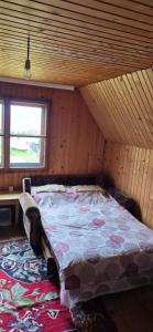 a bedroom with a bed in a attic at Macanovic Country House in Glibaći