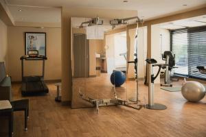 a room with a gym with exercise equipment in it at Hotel & Spa Le Grand Monarque, BW Premier Collection in Chartres