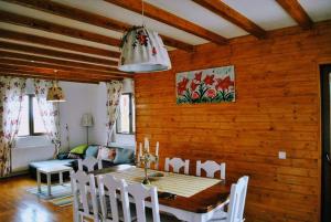 a dining room with a table and a couch at Casa Magnolia in Bran +46 photos
