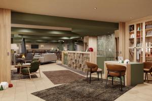 a lobby of a hotel with chairs and tables at VALAMAR Obertauern in Obertauern