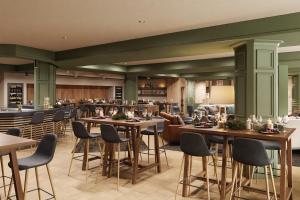 a restaurant with tables and chairs and a bar at VALAMAR Obertauern in Obertauern +64 photos