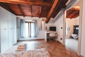 a bedroom with a bed and a desk in a room at Black Paradise Room in Soliera