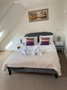 a bedroom with a bed with two towels on it at Penzance Central 1 & 2 Bedroom flats in Penzance