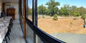 a room with a view of a field from a window at Gîte Chez Clara in Rocamadour