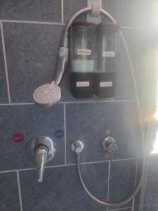 a shower head and a mixer and a sink at The Blue House in Portsmouth +17 photos