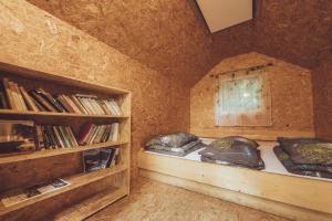 a room with two beds and a book shelf at Ranč Telč in Telč