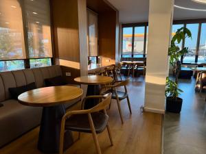 a restaurant with tables and chairs and a couch at Terminal Hotel in Krujë +118 photos