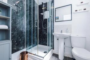 a bathroom with a shower and a sink at Stylish 2-Bed House Sleeps 4 in Saint Helens +60 photos