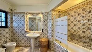 a bathroom with a sink and a toilet and a mirror at Beira Mar - Private Pool - 7 Guests - Albufeira in Albufeira